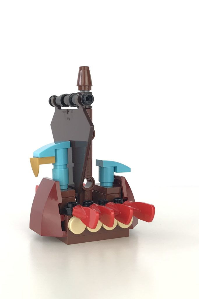 Mini version of a LEGO Viking Ship, with a brown sail and red oars, angled side view.