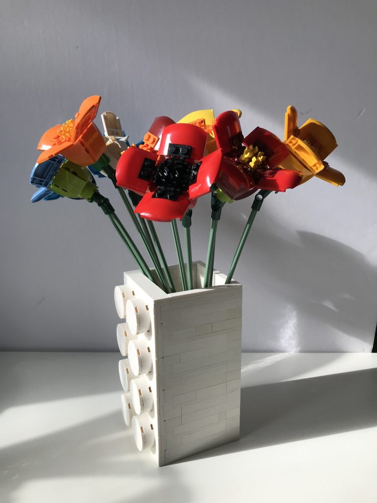 Colorful variations of LEGO's Poppy build from the Flower Bouquet set, in a white Brick Vase SEC by thebricknurse.